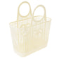 A cream plastic basket with a love heart and flower design on on the front 