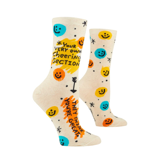 Cream socks with a pattern of yellow & orange. Text reads “YOUR VERY OWN CHEERING SECTION” “ THEY THINK YOU’RE GREAT”