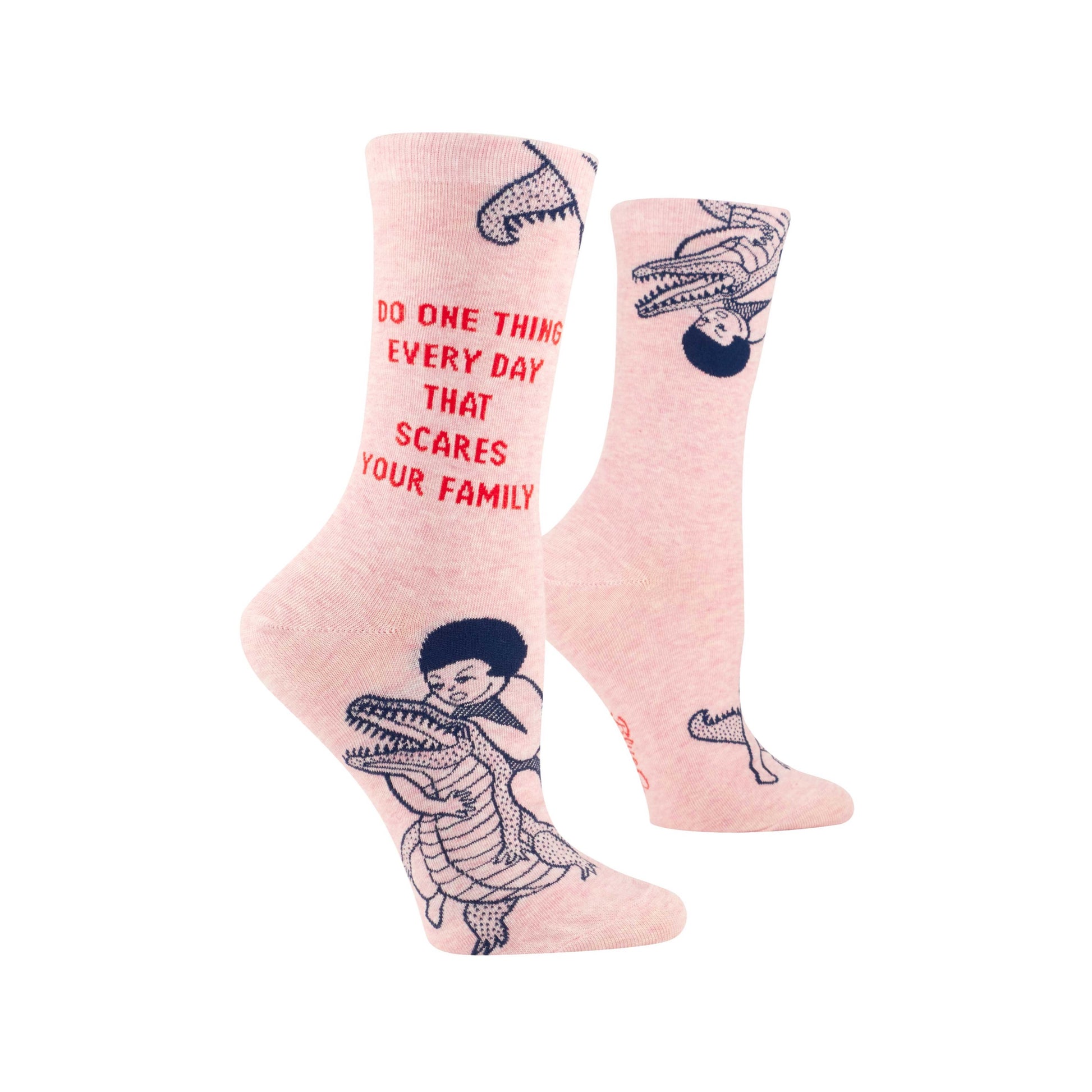 A pair of pink socks with a person attacking a crocodile on. Text reads “DO ONE THING EVERY DAY THAT SCARES YOUR FAMILY.” 