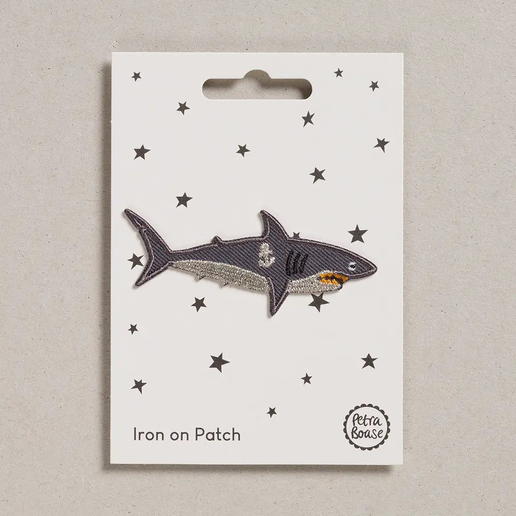 Shark iron on patch on a card with star patterns, brand 'Petra Boase' visible