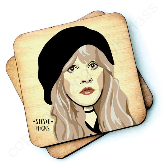 Image shows a wooden drinks coaster with a cartoon graphic of Stevie Nicks on the front