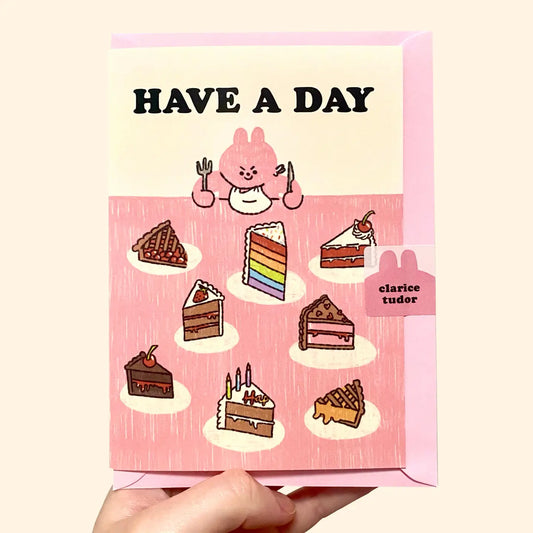 Card with cartoon character and cake illustrations with 'Have a Day' text