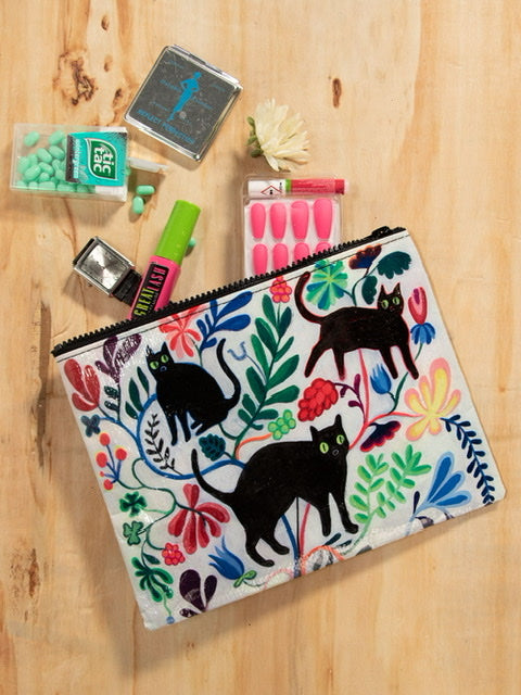 A white Blue Q zipper pouch with 3 black cats on the front and blue, green, yellow and pink floral print all over.