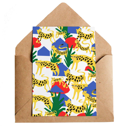 A white card with red, blue and green abstract shapes and lots of drawing so leopards on the front. 