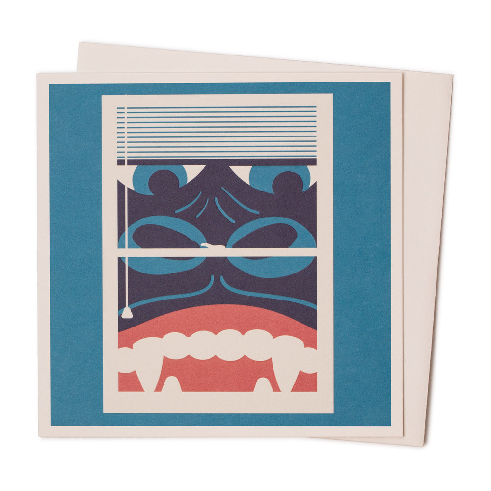 A blue card with an image of king kong peering through a window on the front. 