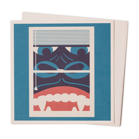 A blue card with an image of king kong peering through a window on the front. 