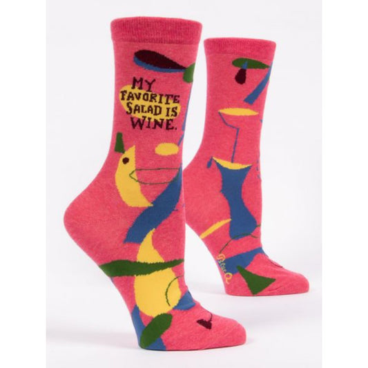 Pink Blue Q women’s socks with blue, green and yellow shapes all over them. The text reads my ‘favourite salad is wine’
