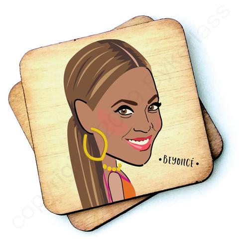 Image shows a wooden drinks coaster with a cartoon graphic of Beyonce on the front