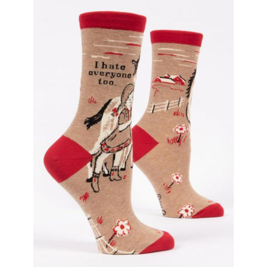 Blue Q socks with the image of a little girl on a horse. They are brown and red and the text reads ‘i hate everyone too’ 
