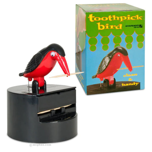 A red and black, Blue Q bird with a toothpick in it’s beak. It’s mounted on a box for dispensing toothpicks