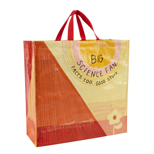 A yellow and orange Blue Q tote bag with a sun and a flower on. The text reads: Big science fan. Facts too. Good stuff.