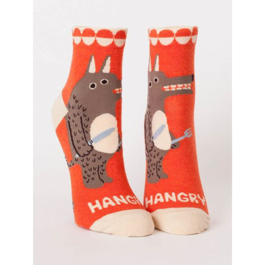 Orange Blue Q socks with a picture of a bear holding a knife and fork on the front. The text on the socks reads ‘hangry’