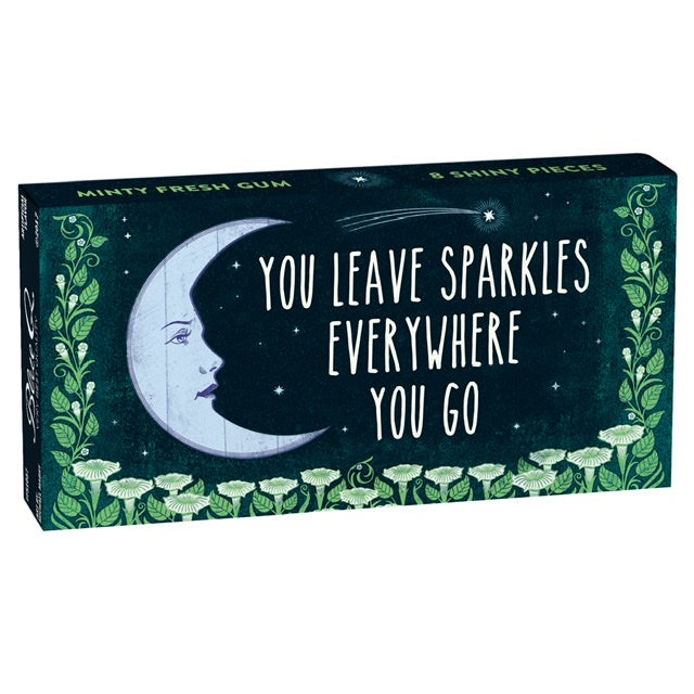 A Box of Blue Q gum with a moon and green flowers on the front. The text reads: You leave sparkles everywhere you go