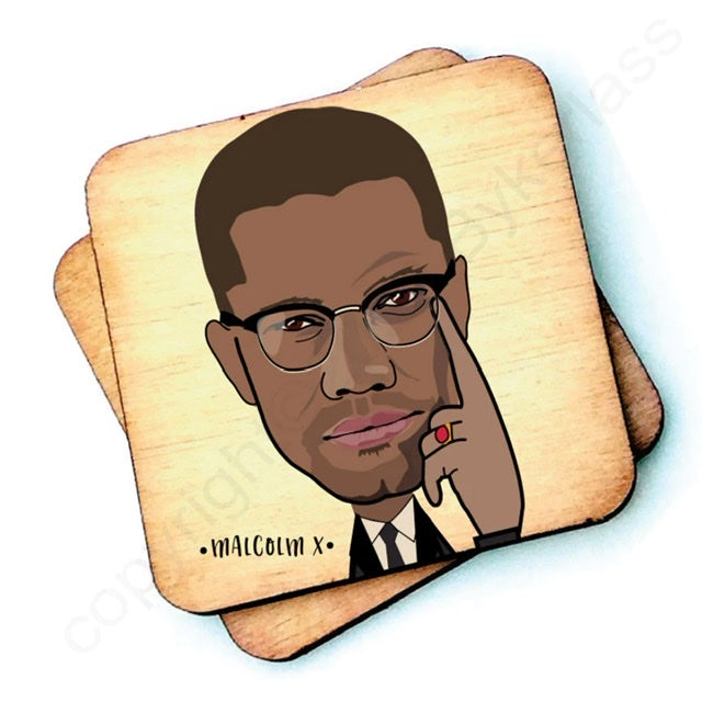 Image shows a wooden drinks coaster with a cartoon graphic of Malcom X on the front