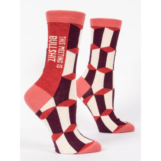 Blue Q socks with a red, maroon and white geometric print. The text up the side reads: 'This meeting is bullshit'