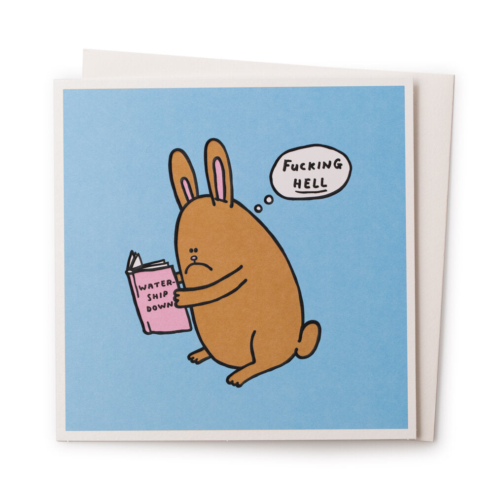 A blue card with a cartookn rabbit on the front that is reading Watership down. There is a speach bubble coming from that rabbit that reads: Fucking HELL