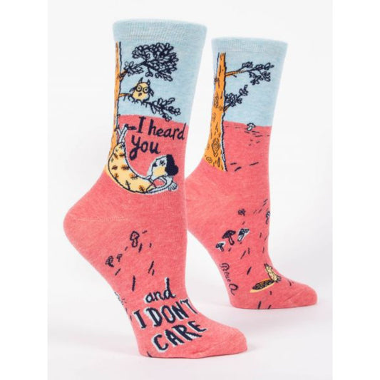 Blue and pink Blue Q socks with a girl laying down against a tree. The text reads 'I heard you and I don't care'