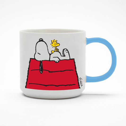 A white mug with a blue handle. There is a graphic of Snoopy laying on top of a shed with Woodstock sat on top of his belly.