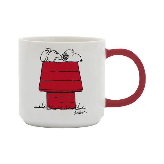 A white mug with a red handle.  The image on the mug shows Snoopy asleep on top of a house 