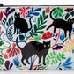 A white Blue Q zipper pouch with 3 black cats on the front and blue, green, yellow and pink floral print all over.