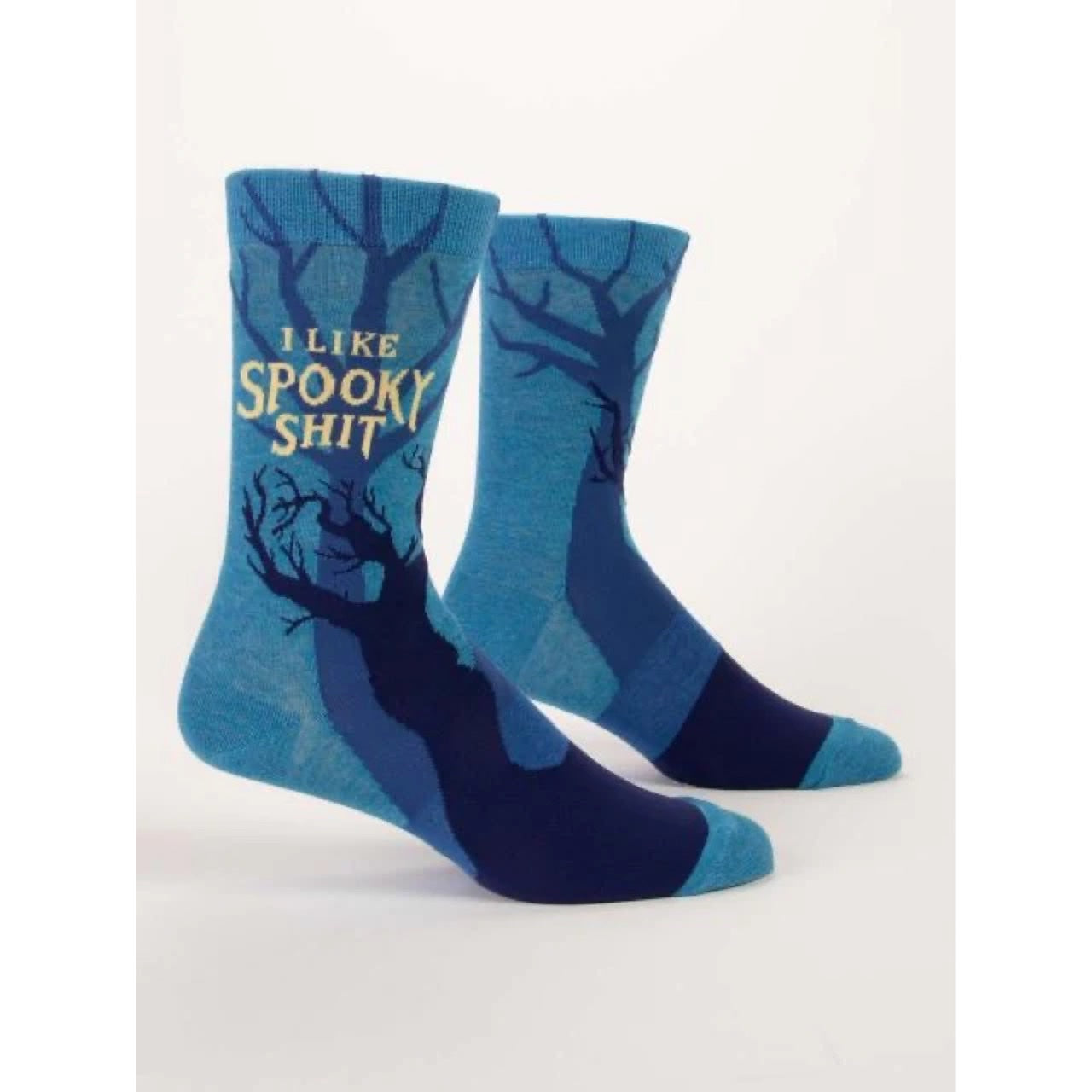 Blue Q socks that are blue with dark and mysterious trees all over. The text on the socks reads ‘I like spooky shit’