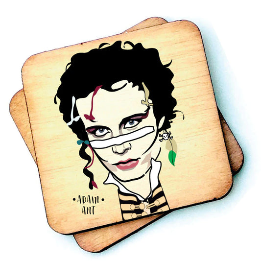 Image shows a wooden drinks coaster with a cartoon graphic of Adam Ant on the front