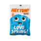A sweet packet with a blue character on the front and a smiley worm. The text reads: Hey Yum! Organic vegan candy