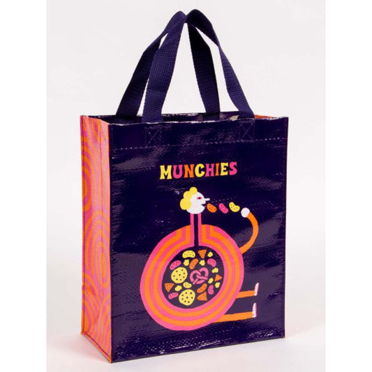 A purple Blue Q lunch bag with a round cartoon character shovelling food into his mouth. The text reads: 'Munchies'