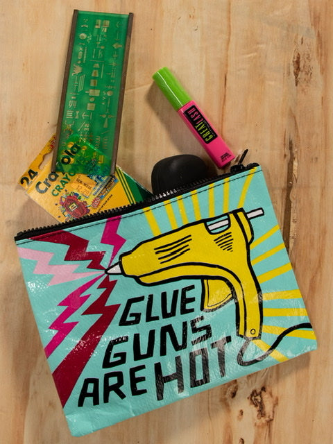 A light blue zipper pouch with a yellow glue gun and purple and pink zig zags. The text reads: ' Glue guns are hot'