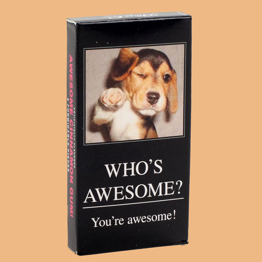 Blue Q gum with a dog on the front that is pointing out at the reader. The text reads: Who's awesome? You're awesome!