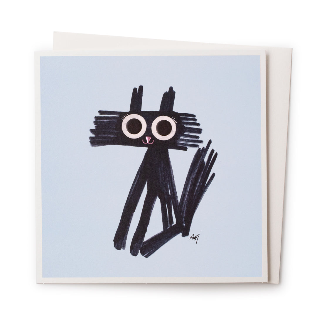 A blue card with a black drawing on the front of a cat like animal with huge eyes and cute metallic pink smile 