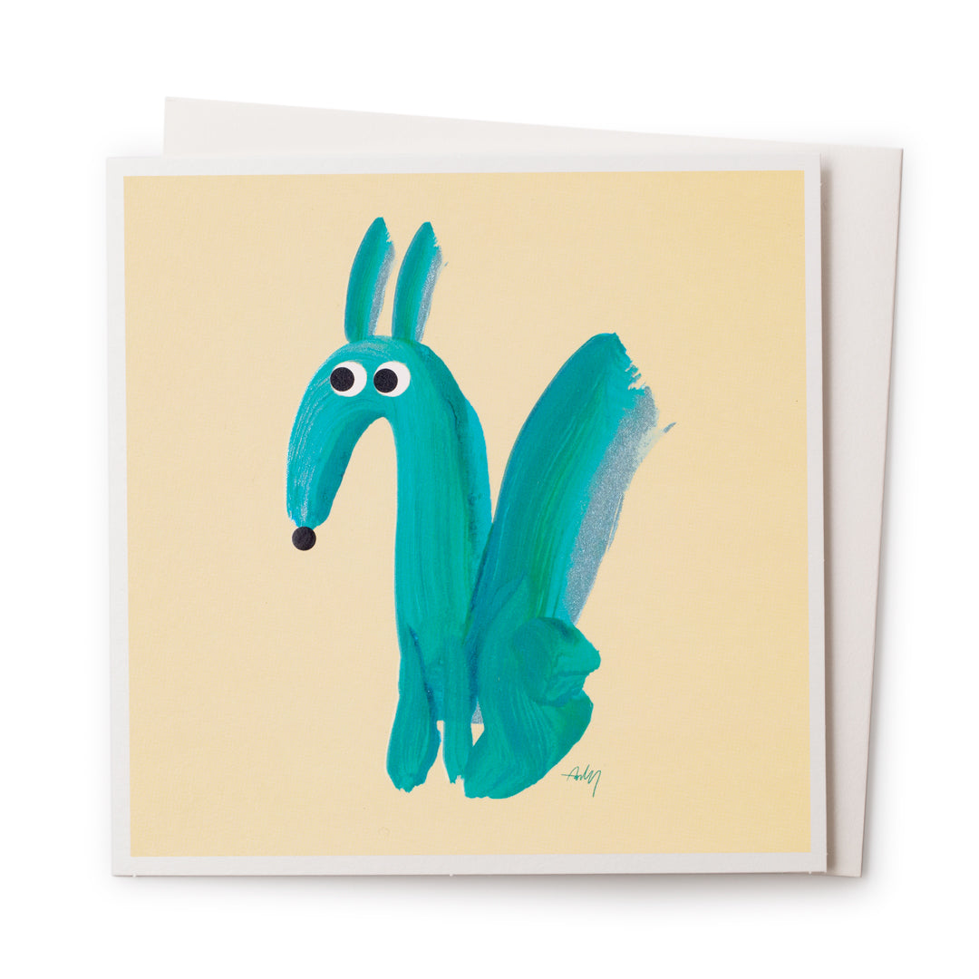 A light yellow cards with a blue metallic painting of a long nose dog on the front.