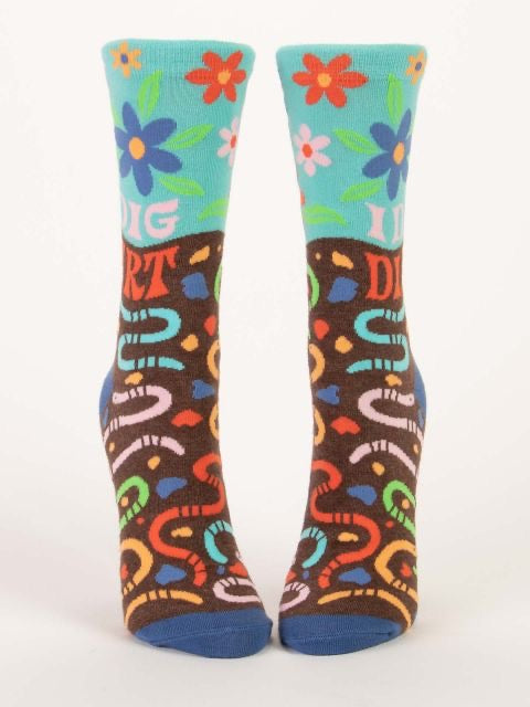 Blue Q women's socks with colourful flowers and worms printed all over. The text on the socks reads ‘i dig dirt’ 