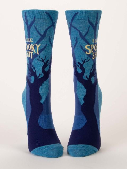 Blue Q socks that are blue with dark and mysterious trees all over. The text on the socks reads ‘I like spooky shit’