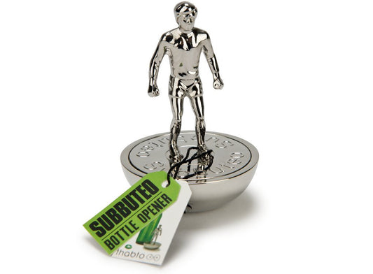 A silver metal bottle opener shaped like one of the Subbuteo football pieces. 