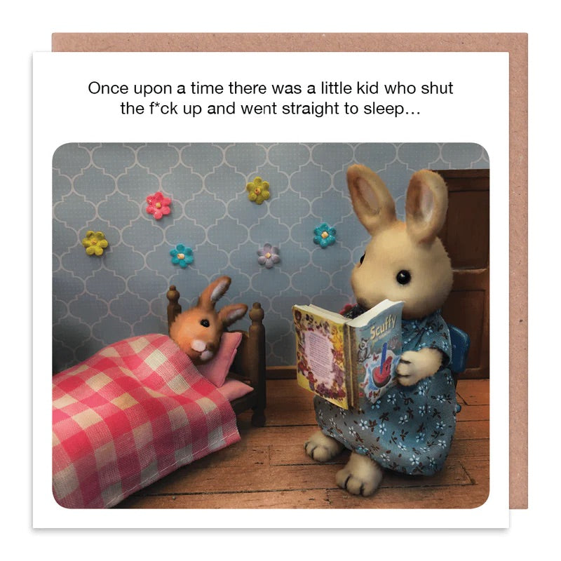 A white card with a Mother rabbit reading to a baby rabbit that is tucked up in bed. The text on the card reads: Once upon a time there was a little kid who shut the f*ck up and whet straight to sleep...