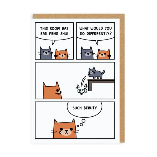 A white card with a comic strip on the front of a ginger and a grey cat that push a vase off the table.  The text on the card reads: This room has bad feng sui - What would you do differently? - Such beauty 