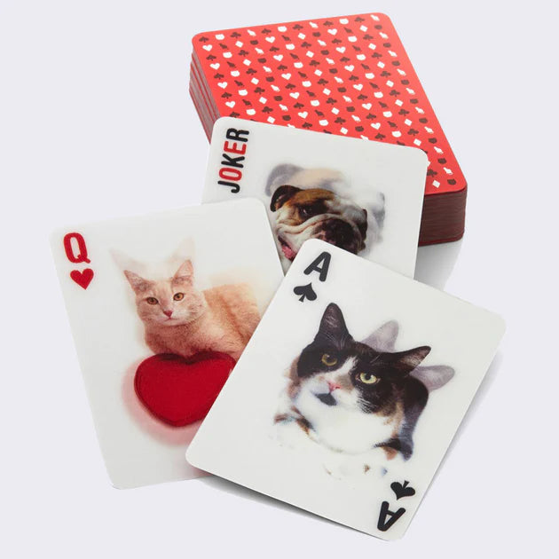 3 lenticular card playing cards with a dog joker on top of a deck of cards. 